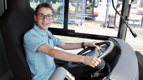 Ein Jugendlicher sitzt am Steuer eines Linienbusses