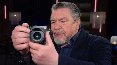 Schauspieler und Fotograf Armin Rohde mit Kamera.