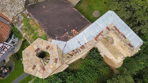 Vogelperspektive von oben auf die Mauern und einen Turm der Burgruine Wallrabenstein