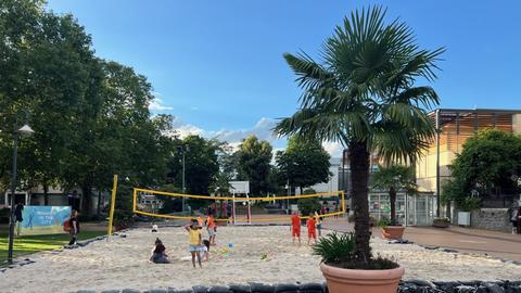 Sandplatz, auf dem Kinder Volleyball spielen