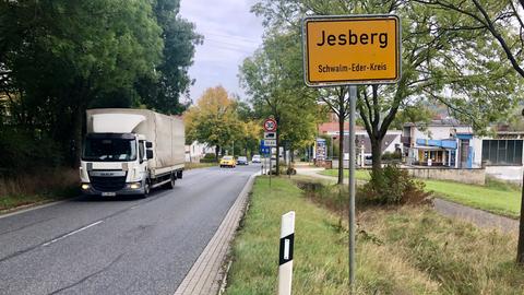 Ortsschild mit der Aufschrift Jesberg, daneben fährt ein LKW