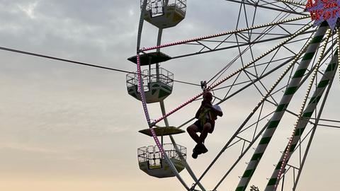 Ein Mitglied der Bergwacht hängt am Riesenrad.