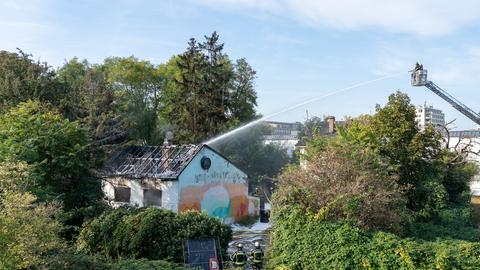 Feuerwehrmann löscht Brandhaus von einer Drehleiter aus