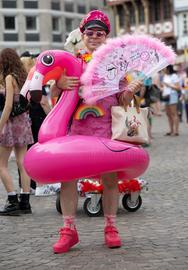 CSD-Teilnehmer mit Flamingo-Schwimmring und rosafarbenem Feder-Fächer