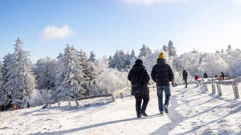 Dicker Raureif bei blauem Himmel auf dem Großen Feldberg - Spaziergänger auf Wanderweg