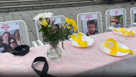 The Israeli hostages still held captive by Hamas were remembered in Darmstadt with pictures on empty chairs at a long table