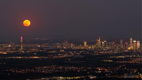 Mond über Lichtern der Stadt