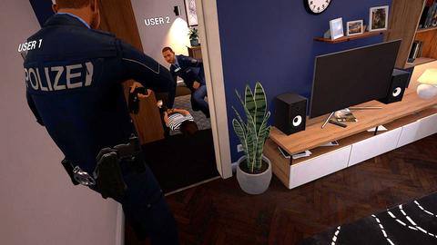 Digitales Bild aus einem Virtual-Reality-Player zur Simulation von Polizeieinsätzen: Ein Polizist von hinten schaut in den Flur einer Wohnung, in der ein anderer Polizist über einer anderen Person kniet und sie festhält