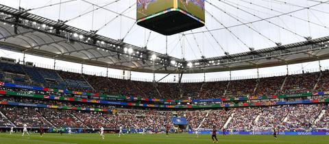 Foto eines voll besetzen Fußballstadions während eines Spiels.