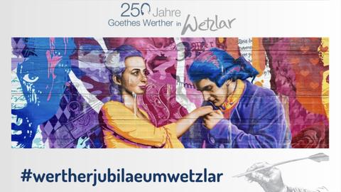 Bunte Darstellung von einer Frau und einem Mann, der ihre Hand küsst. Gerahmt von zwei Schriftzügen: oben  "250 Jahre Goethes Werther in Wetzlar", unten "#wertherjubilaeumwetzlar".