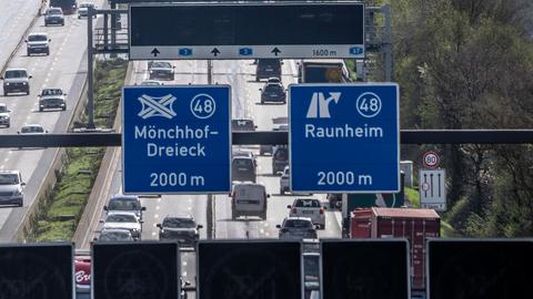 Auf zwei Autobahnschildern steht "Mönchhof Dreieck" und "Raunheim".